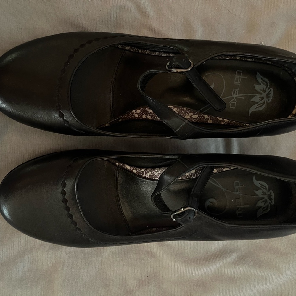 Dansko platform Mary Janes in classic black with detailed stitching.
